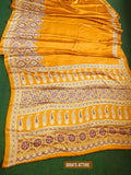 Yellow saree with intricate patterns on a green background