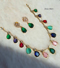 Gold-plated traditional jewelry set featuring a necklace, earrings. colorful teardrop-shaped gemstones in green, blue, pink, red, and purple