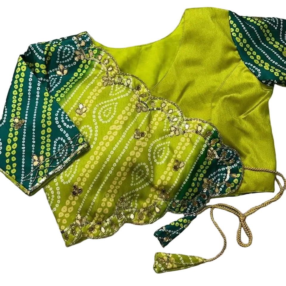 Green and blue patterned Readymade blouse with gold accents on a gray surface