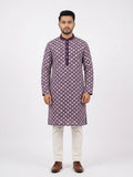 Front facing full-length shot of a man wearing a deep purple soft silk kurta with all-over white geometric embroidered diamond patterns, paired with white trousers and brown dress shoes.Dark purple solid Mandarin collar and placket that balance the detailed body embroidery.