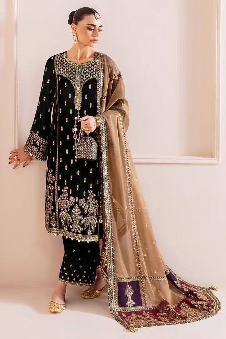 A model wearing on a pakistani bortle green 9000 micro Velvet 3-Piece Kurta Set, Provides a plush, soft-to-touch feel with a rich, light-catching sheen.Finished with decorative borders, rich contrasting color blocks, and fancy tassels to elevate the formal drape.Intricate patterns spanning the yoke, front panels, sleeves, and trouser hems.