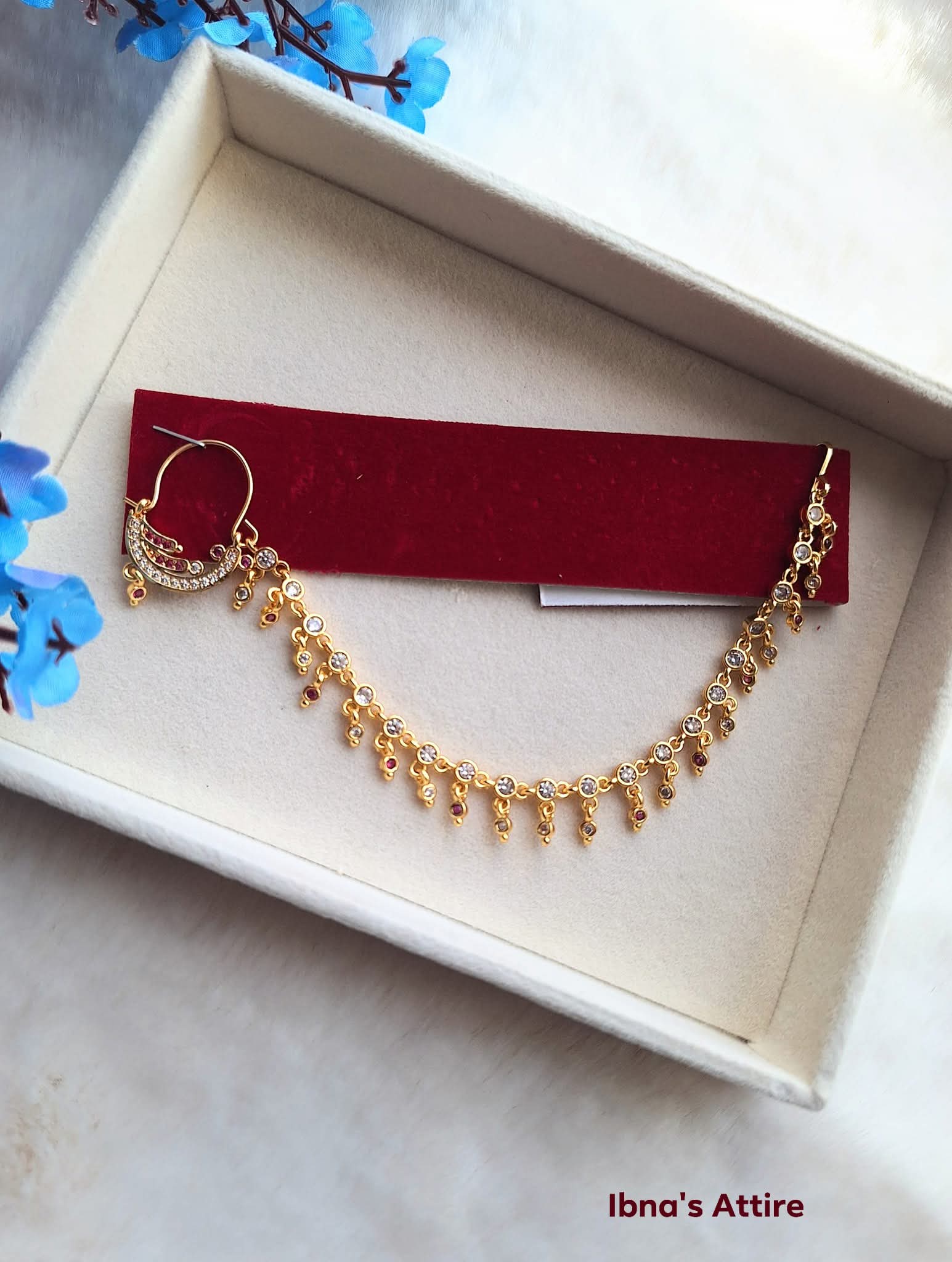 Gold plated nath with chain on beige jewelry display box