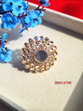 Gold plated mirror cut Adjustable ring with intricate design on a textured surface
