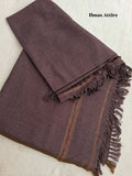 Folded rich brown-purple Pashmina winter wool shawl showcasing a textured weave, detailed multi-color border stripe, and fringe tassels on a soft background.