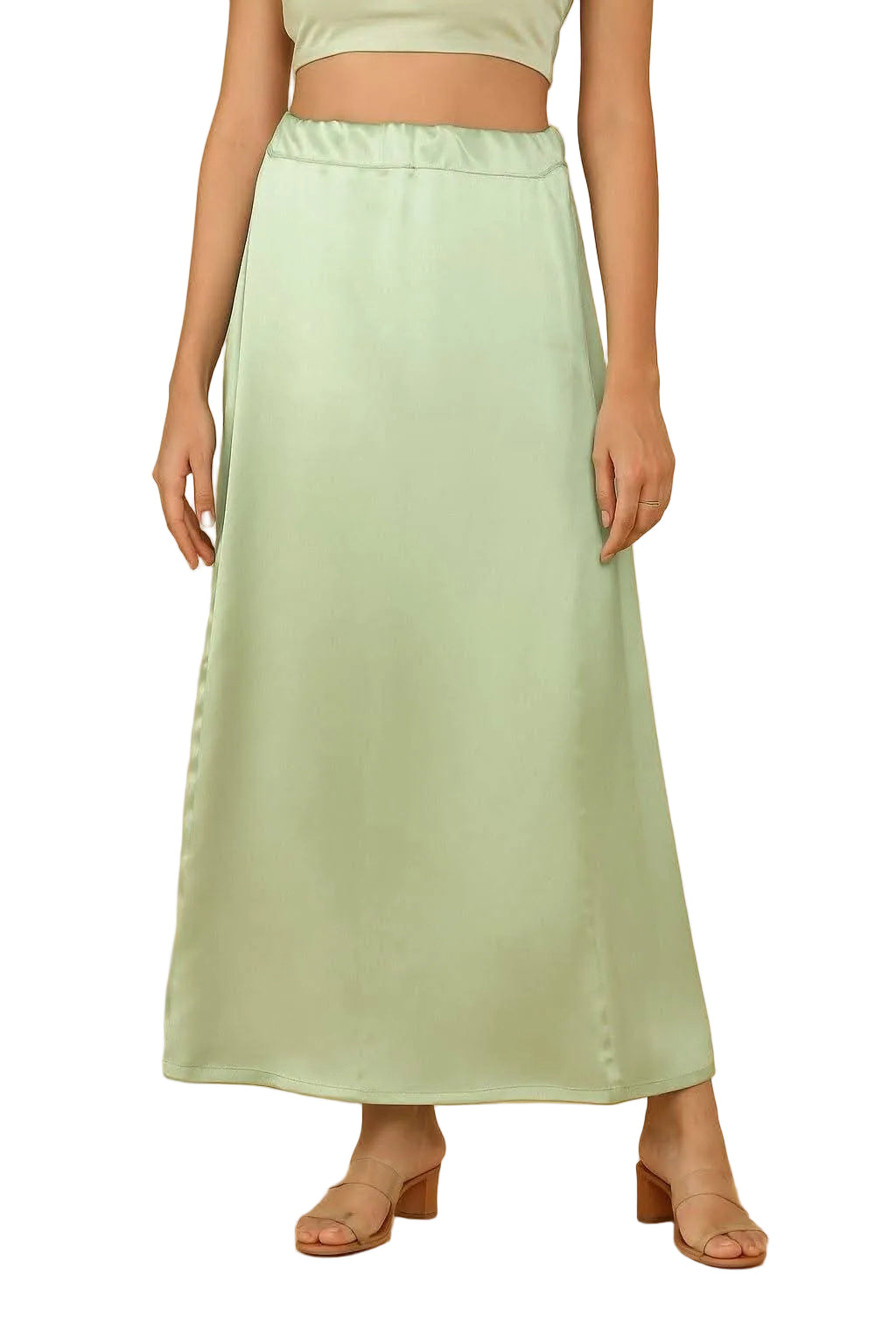A model wearing a light pista green satin petticoat maxi skirt with a matching crop top, shown against a solid white background.