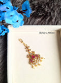 Peacock style gold-plated American Diamond head ornament on a jewellary box