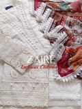 A folded white Stitched Luxury Chikankari 3-Piece Suit-Fine white-on-white thread embroidery complemented by intricate patterns and pearl embellishments.A vibrant multi-color contrasting print framed elegantly with a 4-sided detailed lace stitch.Clean, matching tailored trousers designed for effortless comfort and balance.