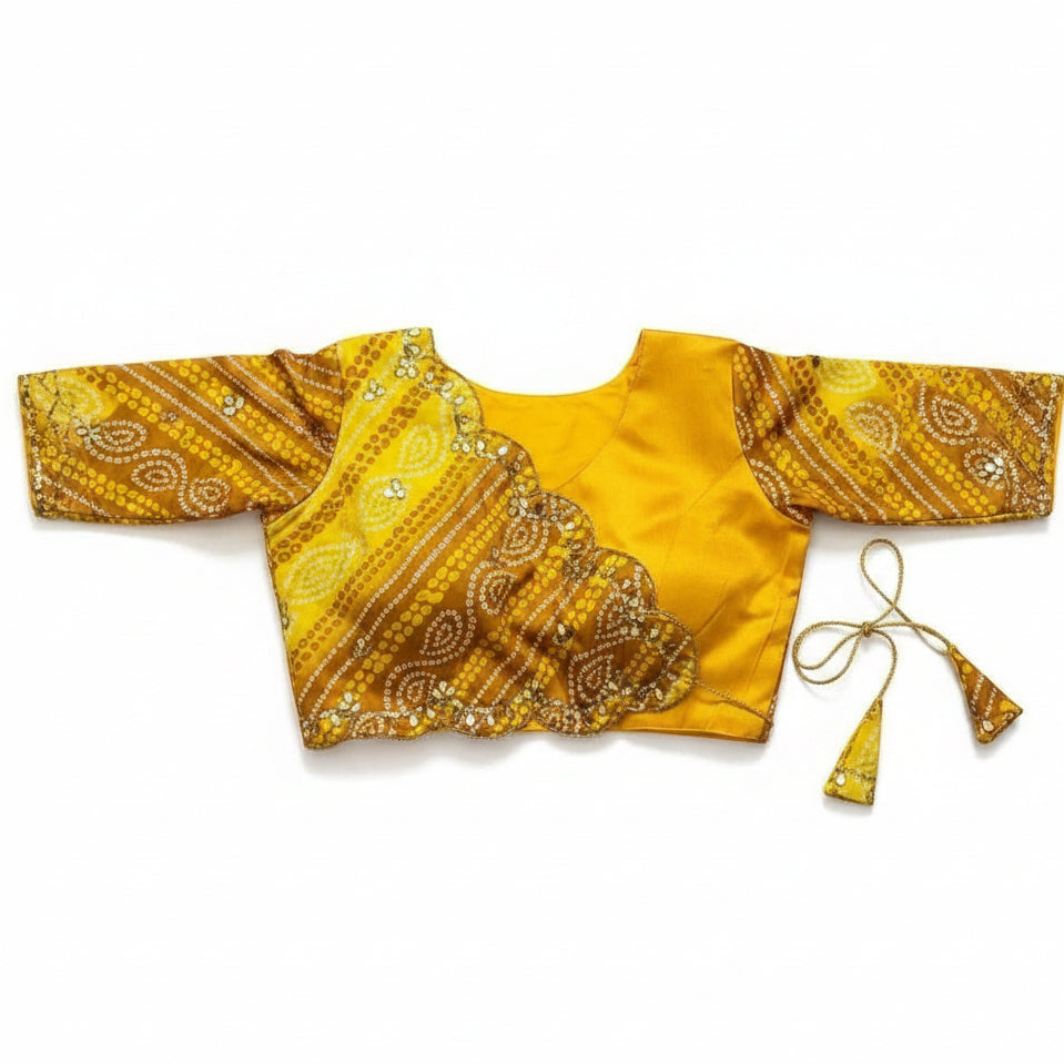 Yellow silk blouse with intricate patterns on a white surface