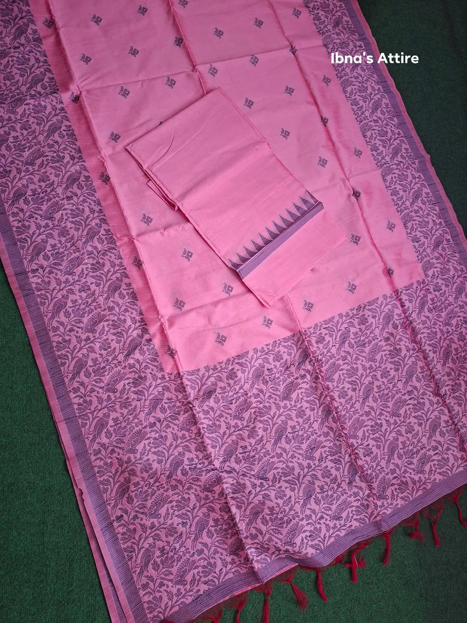 Pink madhibani gicha silk saree on a dark green textured surface. 