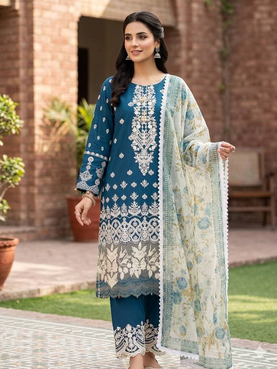 Woman wearing a blue traditional embroidered outfit with a shawl outdoors.
