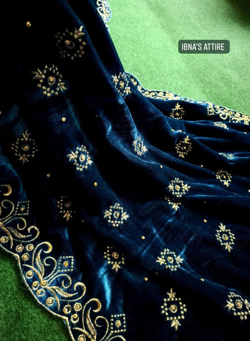 Closed pose of a teal blue zari embroidery with stone worked velvet shawl 
