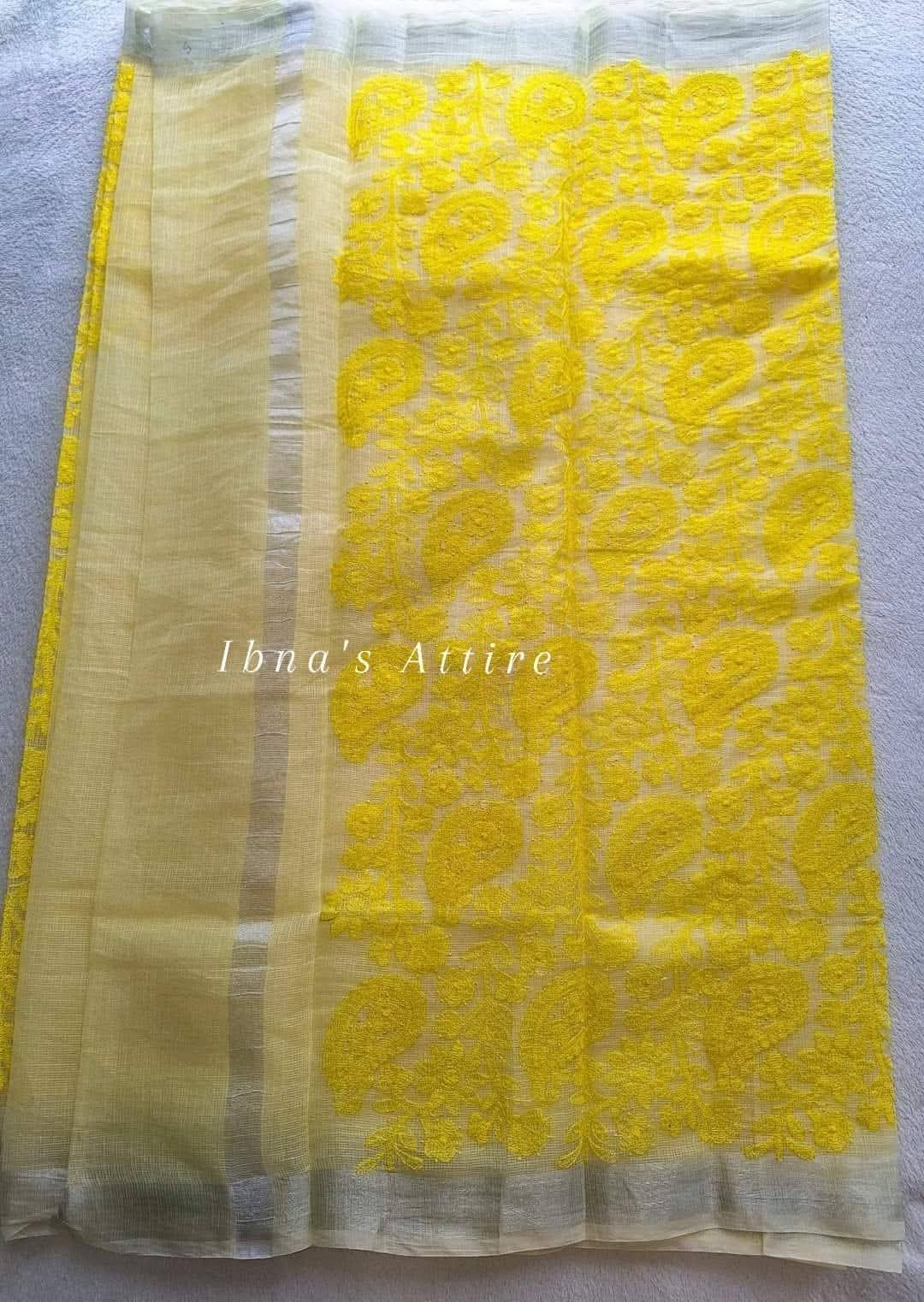 A yellow lakhnouvi work pure kota saree on a white background 