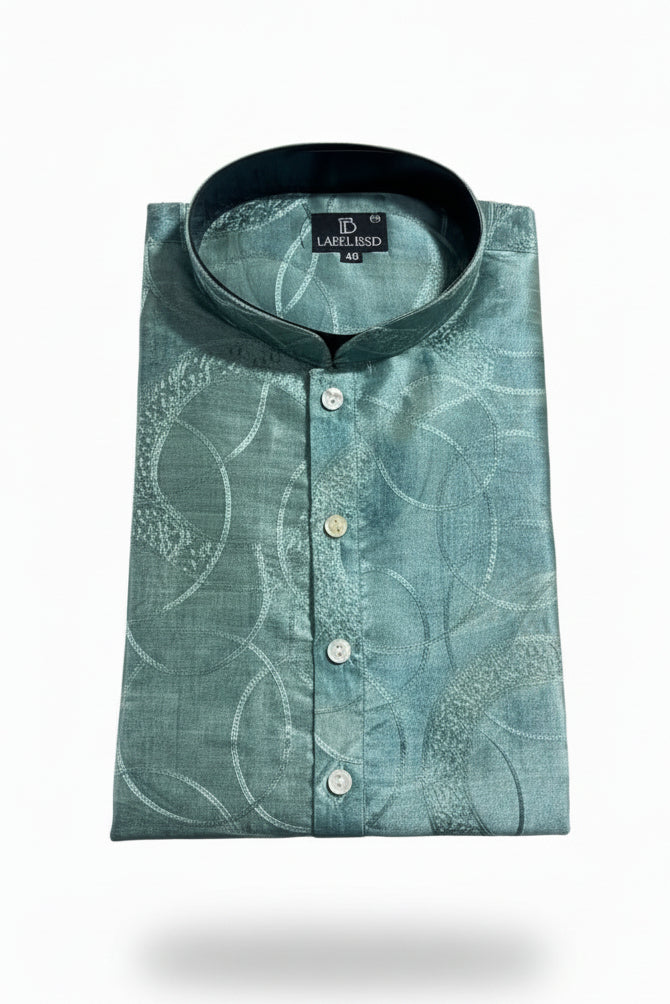 Featuring a folded Designer Ethnic Kurta / Panjabi in pure silk - aqua green color. Tailored with a classic mandarin collar and a neat button placket.A modern digital print base beautifully overlaid with intricate chainstitch thread work.