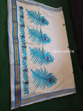 Folded off-white pure cotton Kerala Kasavu saree showcasing woven gold-and-blue border stripes alongside detailed blue embroidered peacock feathers.Lightweight and breathable fabric ensuring all-day comfort during festive gatherings and weddings.Traditional gold and blue woven stripes running along the selvage.