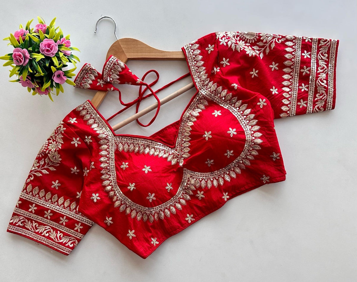 Featuring Traditional Heavy Embroidered Readymade Saree Blouse-Heavy scalloped leaf/floral zari borders outlining the neckline and sleeve cuffs.Scattered starry motif embroidery with embedded sequins across the body for subtle sparkle.Comes with matching embroidered fabric tassels attached to back ties (dori).