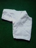 Soft Georgette Chikankari Blouse white color lying on a greeny background 