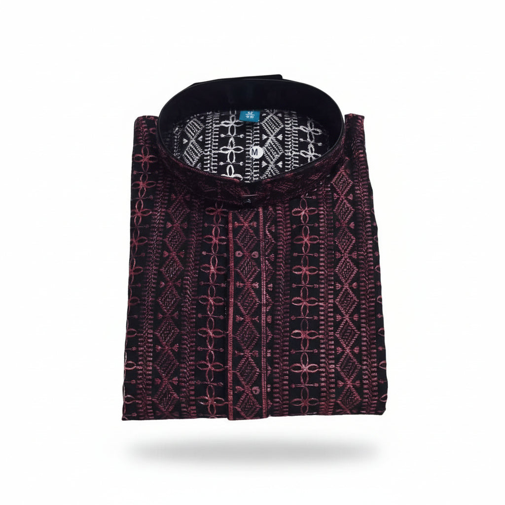 A folded patterned panjabi / kurta , The garment has a dark base with intricate pink geometric and floral embroidery.