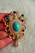 Victorian Revival Filigree Brooch ,A prominent oval center stone accompanied by smaller teardrop turquoise accents, 