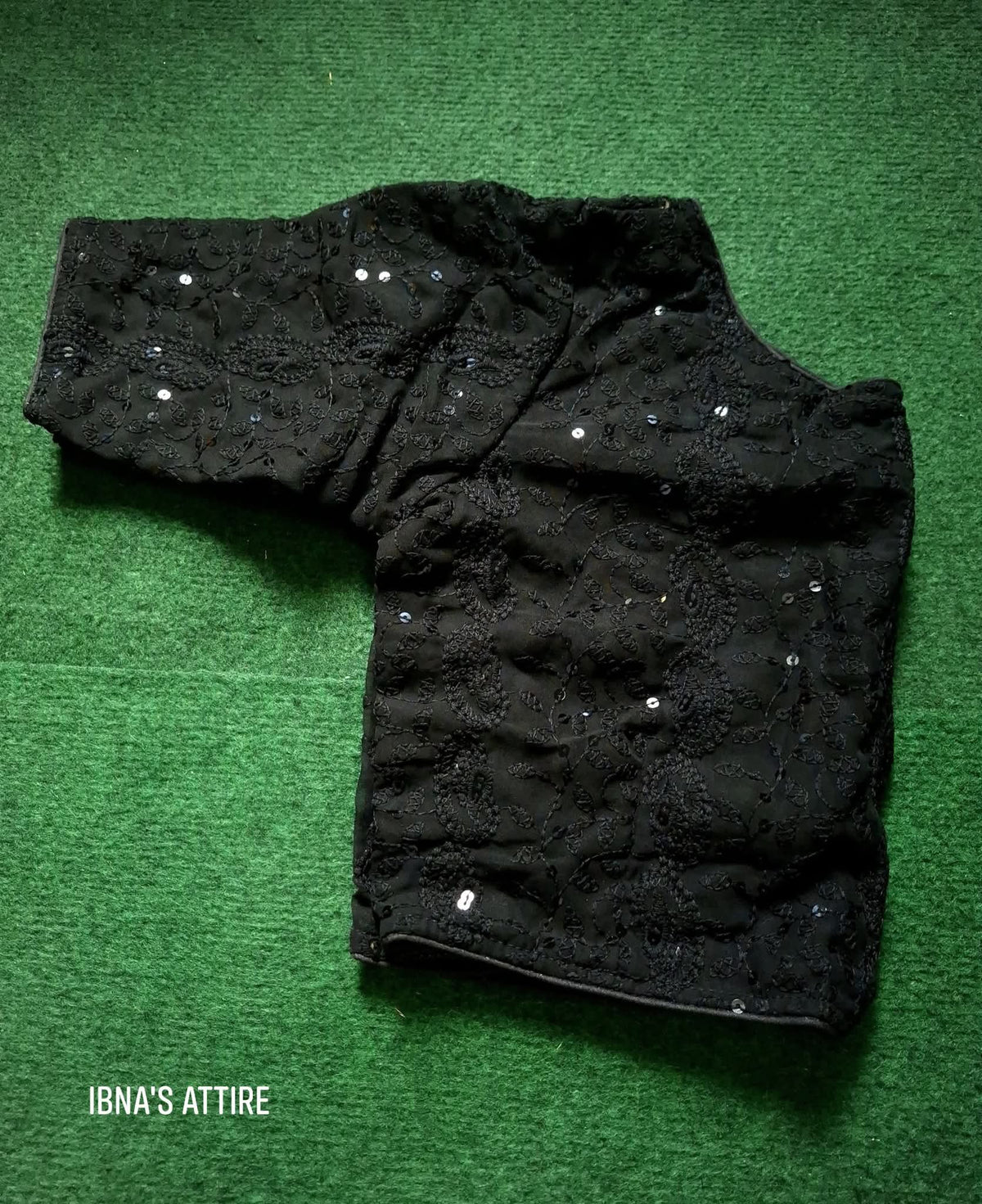 Soft Georgette Chikankari Blouse black color lying on a greeny background