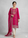 Model standing against a neutral studio backdrop wearing a rich magenta chiffon handworked tunic, matching sequence dupatta, and contrasting off-white embroidered silk trousers. Rich zardozi and bead embellishments across the magenta kameez for a captivating focal point.Contrast off-white silk bottom embellished with matching motif handwork.Flowing chiffon dupatta accented with geometric embroidery and shimmering sequence work.