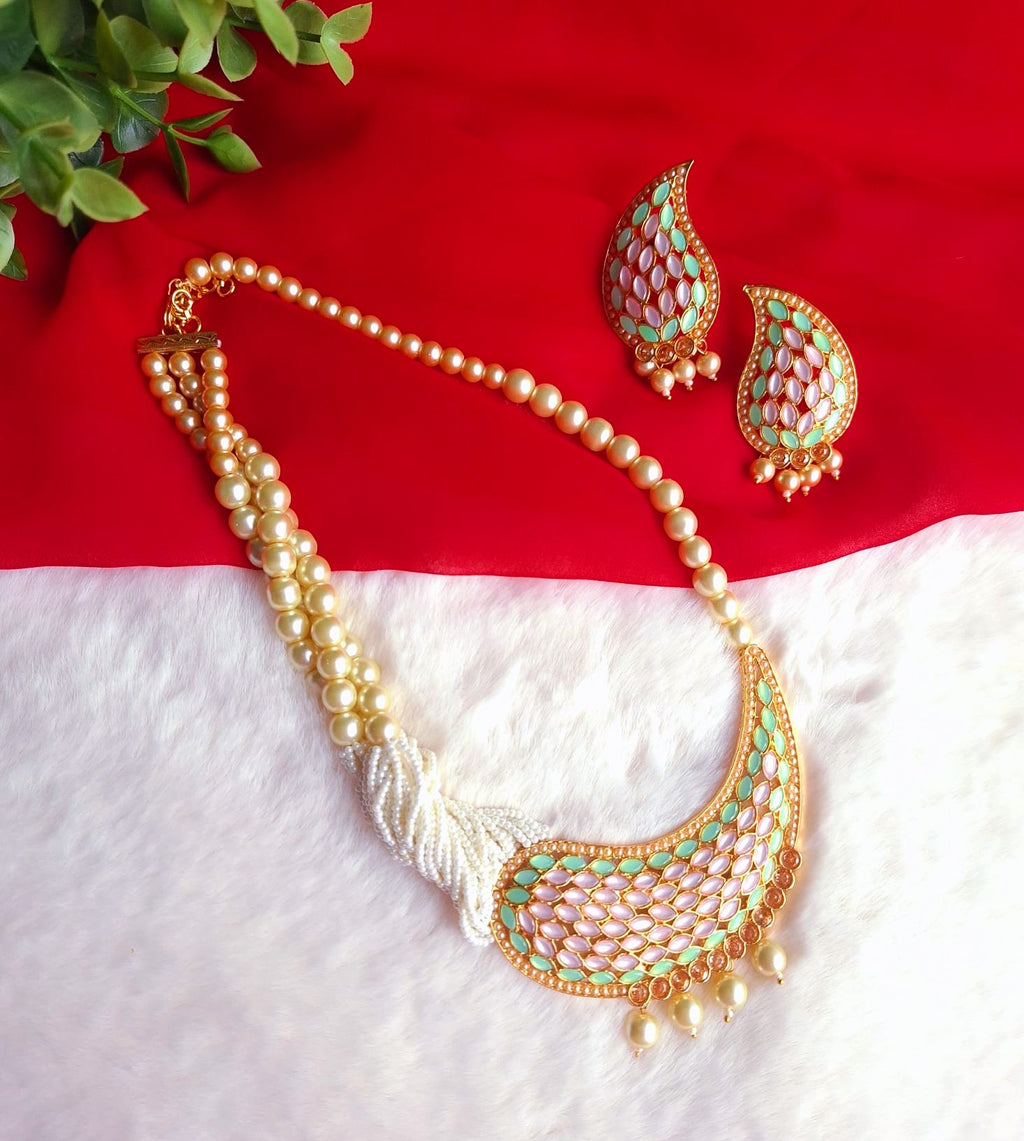 Featuring a Contemporary Ethnic Reverse AD & Pearl Statement Set-Unique marquise-cut stones mounted in reverse orientation, creating a textured, multifaceted play of light and color.Multi-strand cream pearls transition seamlessly into a dense cluster near the statement pendant for a balanced look.A graceful blend of mint green and soft pink framed by bright gold-tone metal work.
