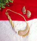 Featuring a Contemporary Ethnic Reverse AD & Pearl Statement Set-Unique marquise-cut stones mounted in reverse orientation, creating a textured, multifaceted play of light and color.Multi-strand cream pearls transition seamlessly into a dense cluster near the statement pendant for a balanced look.A graceful blend of mint green and soft pink framed by bright gold-tone metal work.