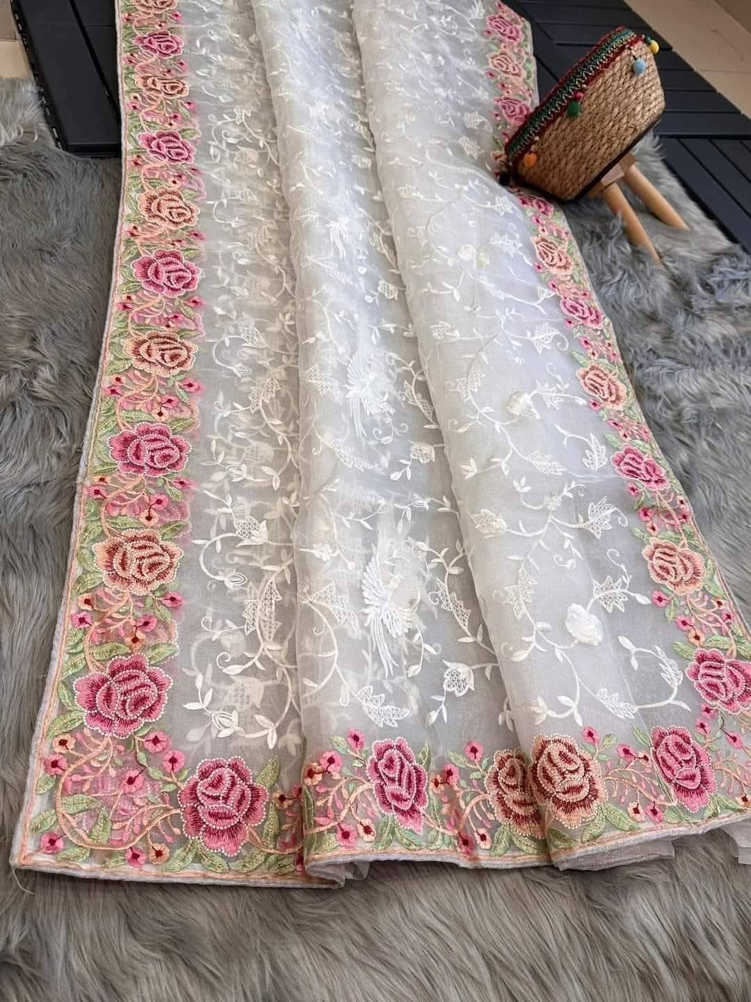 Decorative fabric with floral embroidery on a textured surface