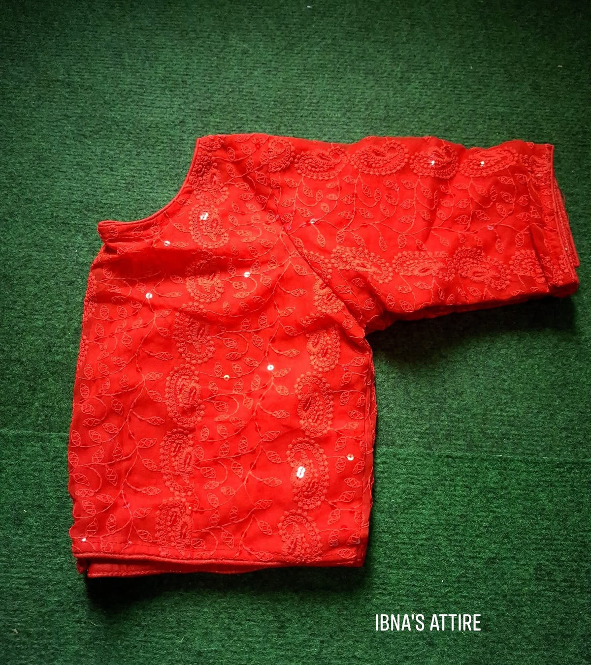 Soft Georgette Chikankari Blouse red color lying on a greeny background
