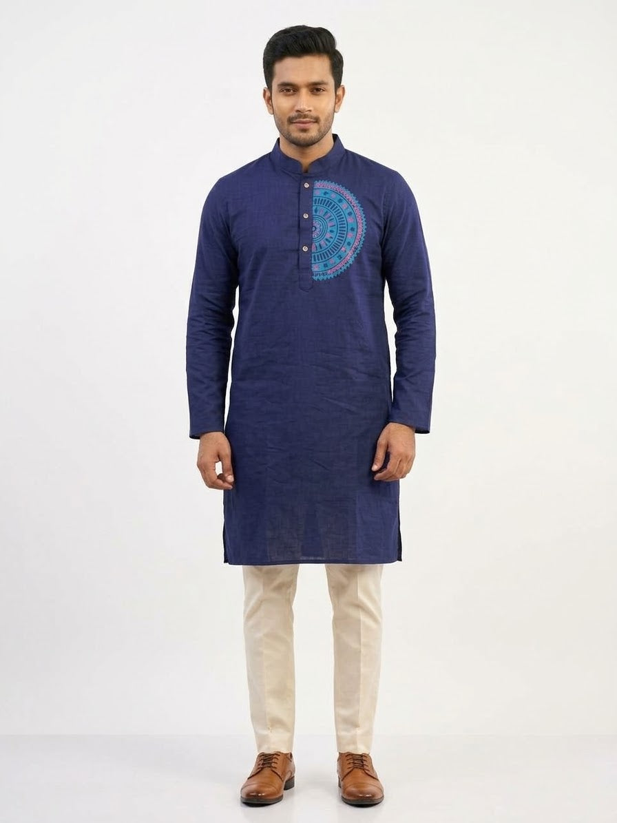 Deep navy blue silk long kurta/panjabi with a turquoise and pink circular mandala motif block-printed on the chest, laid flat against a white fur background. Neat band collar with button placket offering a clean, formal finish.