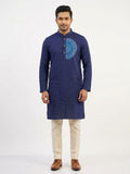 Deep navy blue silk long kurta/panjabi with a turquoise and pink circular mandala motif block-printed on the chest, laid flat against a white fur background. Neat band collar with button placket offering a clean, formal finish.