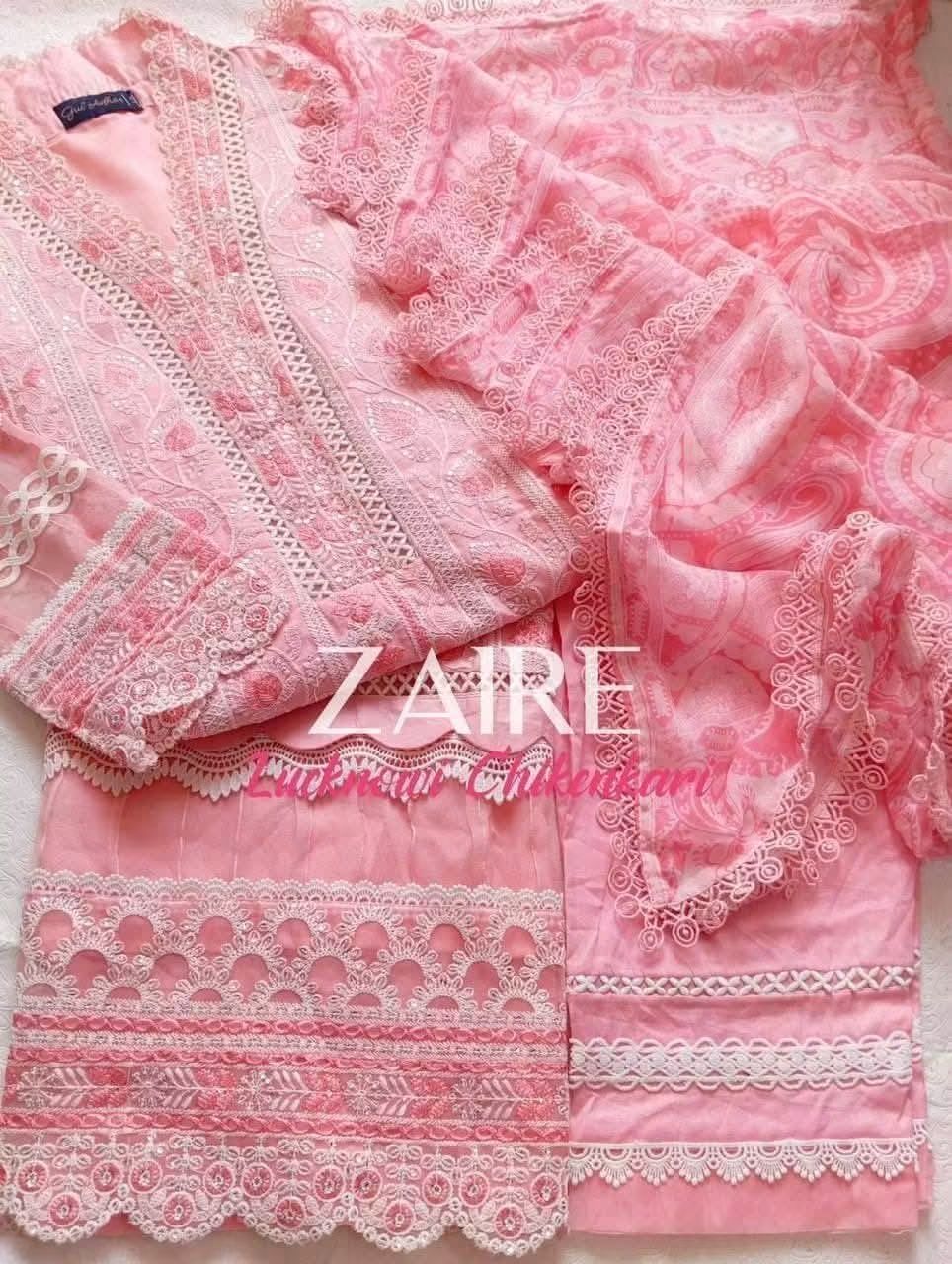 Light Pink embroidered and lace-trimmed traditional Pakistani pure lawn outfit laid flat, featuring a long-sleeve top with lace borders and matching embroidered pants with scalloped lace trim. A large 'Zaire' watermark is overlaid across the center.